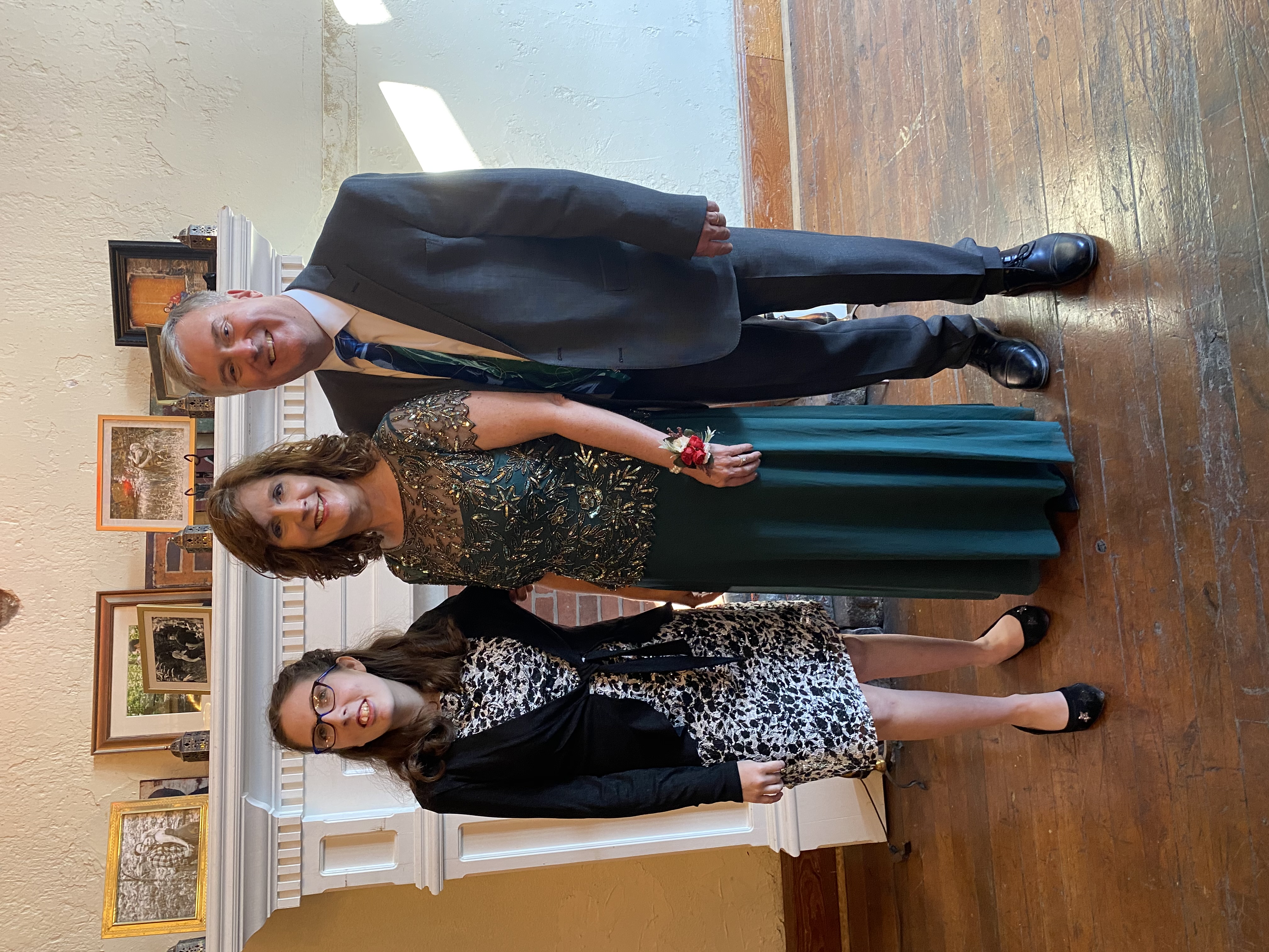 A photo of Susan standing with her daughter and husband