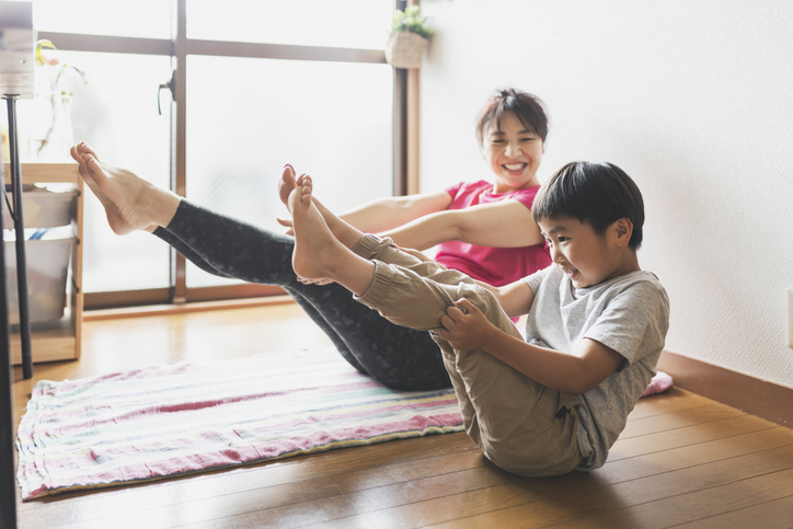 Asian woman and child doing yoga
