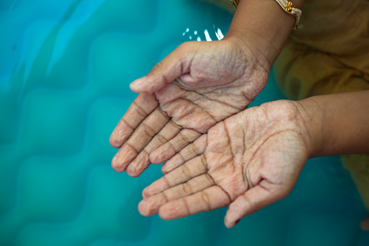 wrinkly hands in a pool