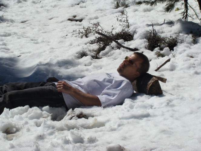 Man lying down in snow in Yosmite National Park in California