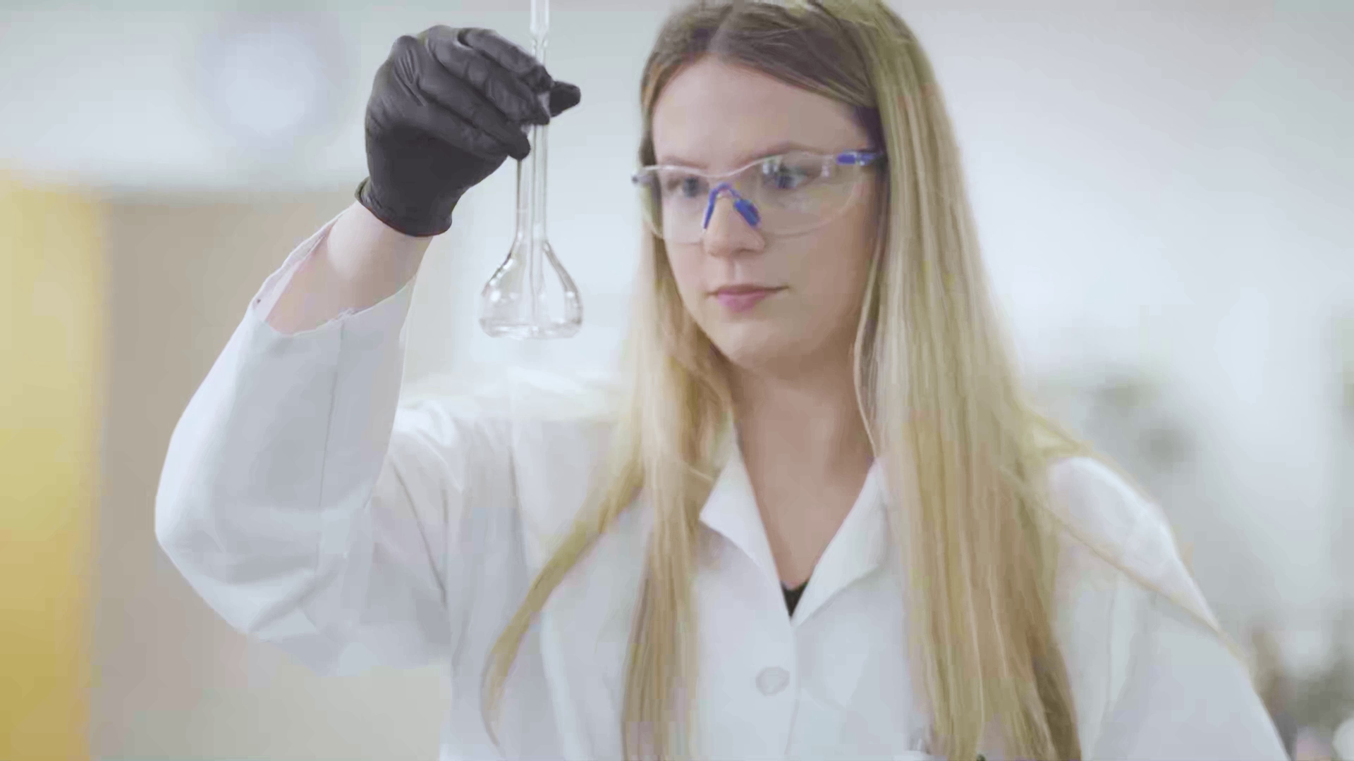 Amber Malloy looking at a test tube.