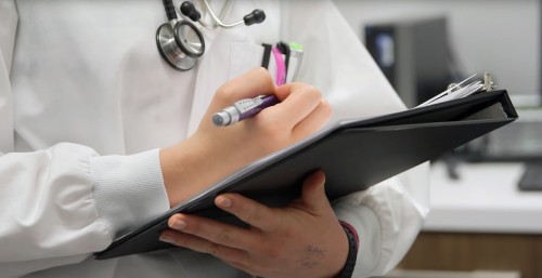 clinical researcher with a folder and stethoscope