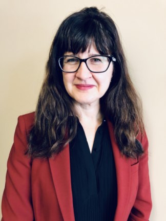 Dr. Lynne Le Sauteur, PhD, in a red blazer. Employee of Altasciences. 