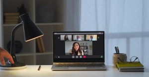Open laptop on a desk with a video conference call window open to show a video call in progress.
